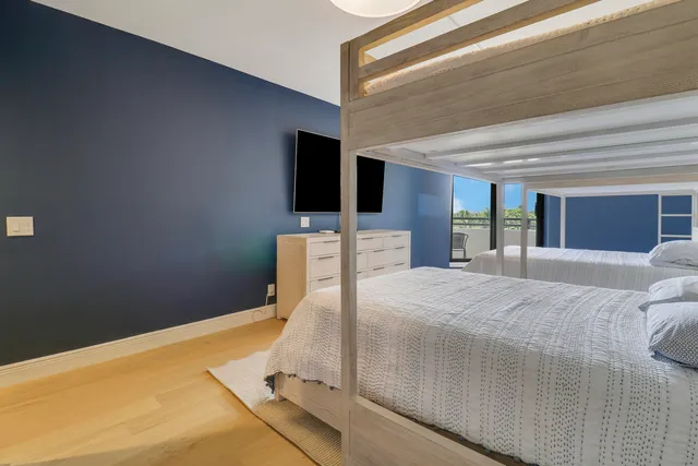 a bedroom with a large bed and a large window