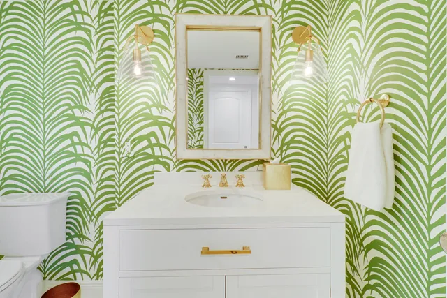 a bathroom with a sink a toilet and a shower curtain