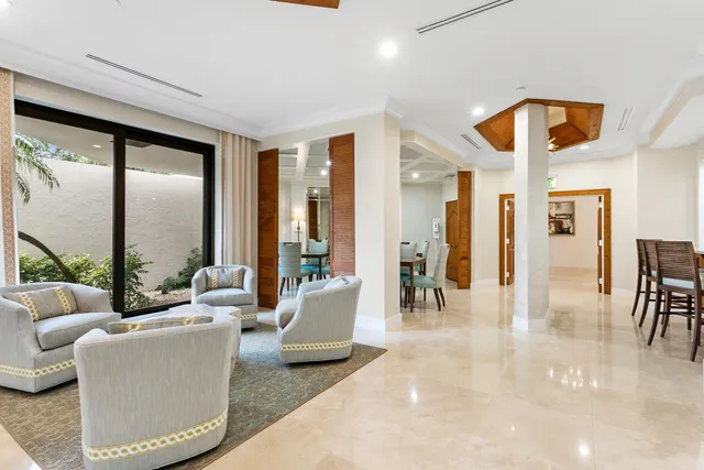 a large white kitchen with kitchen island white cabinets and stainless steel appliances