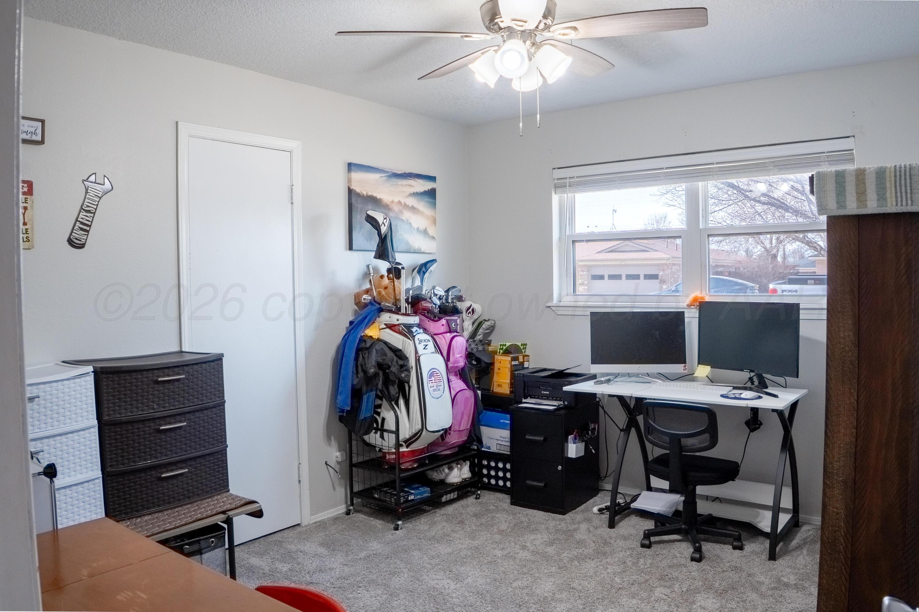 415 Mustang Street Fritch, TX 79036 - Photo 14 of 23 a view of a workspace with furniture and a window