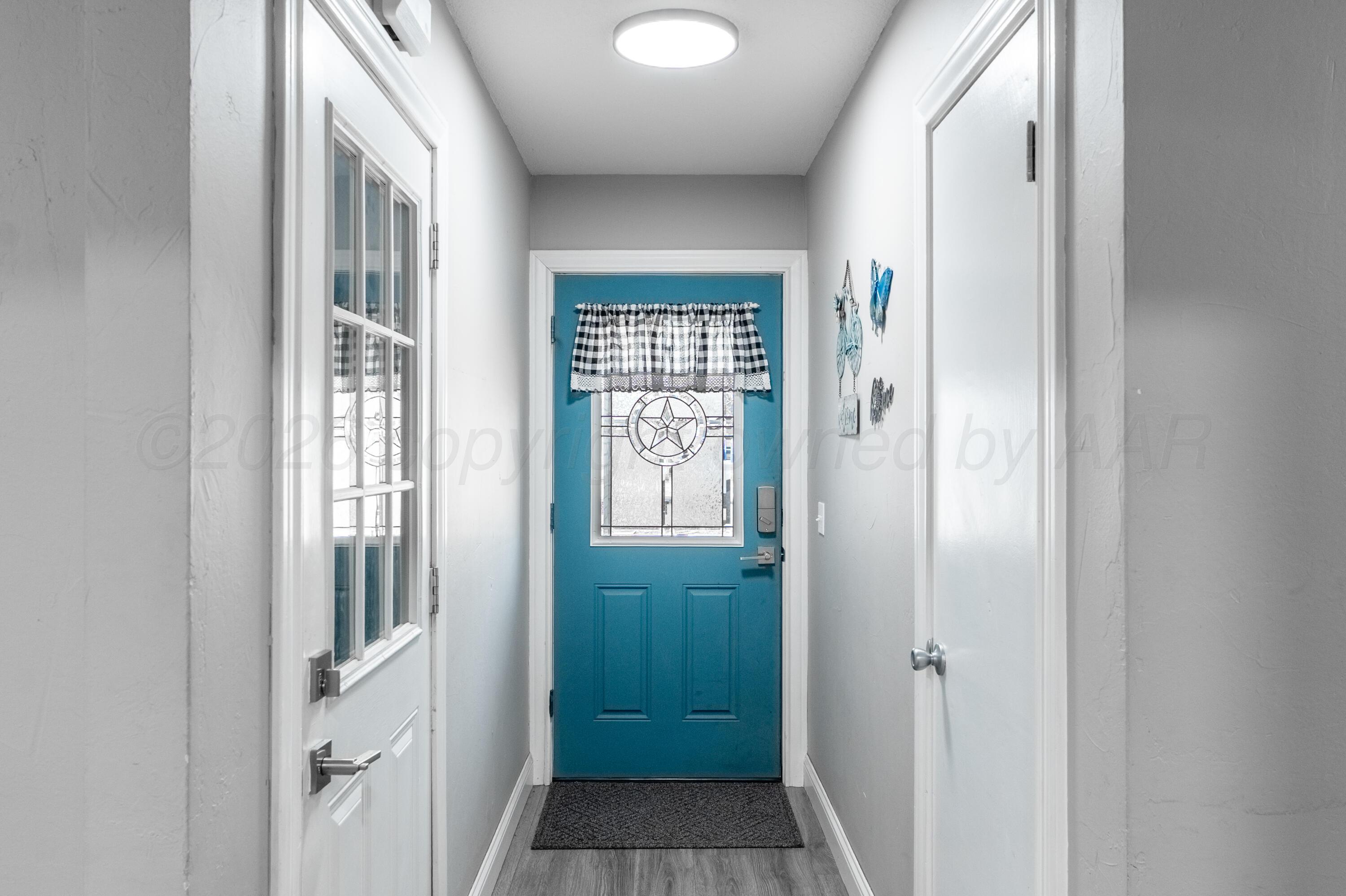 415 Mustang Street Fritch, TX 79036 - Photo 5 of 23 a view of a hallway with windows and entryway