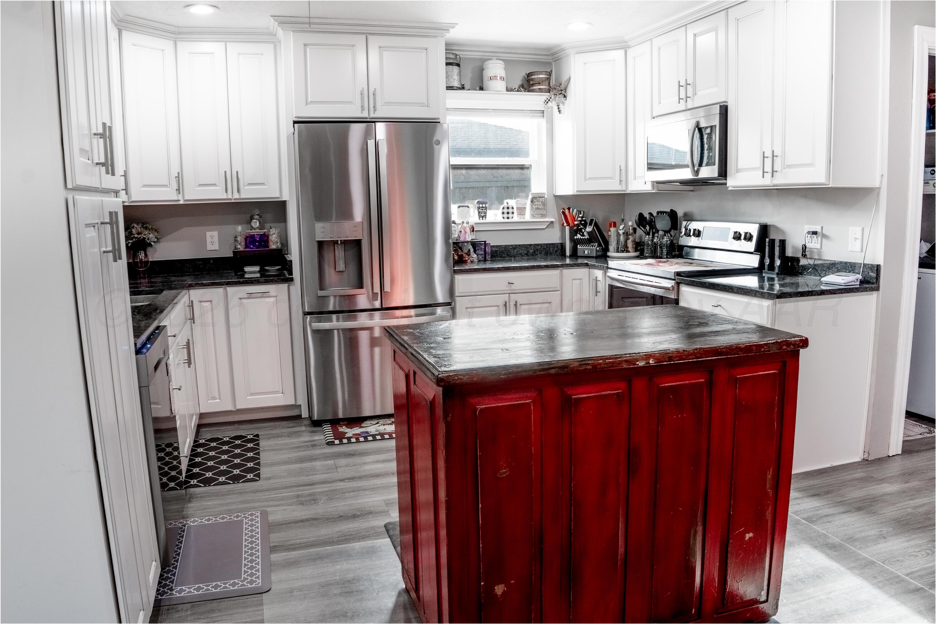 415 Mustang Street Fritch, TX 79036 - Photo 7 of 23 a kitchen with stainless steel appliances granite countertop a refrigerator stove and sink