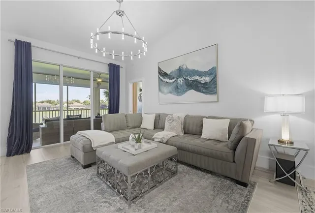 a living room with furniture and a chandelier