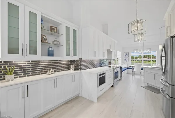 a kitchen with refrigerator cabinets and a sink