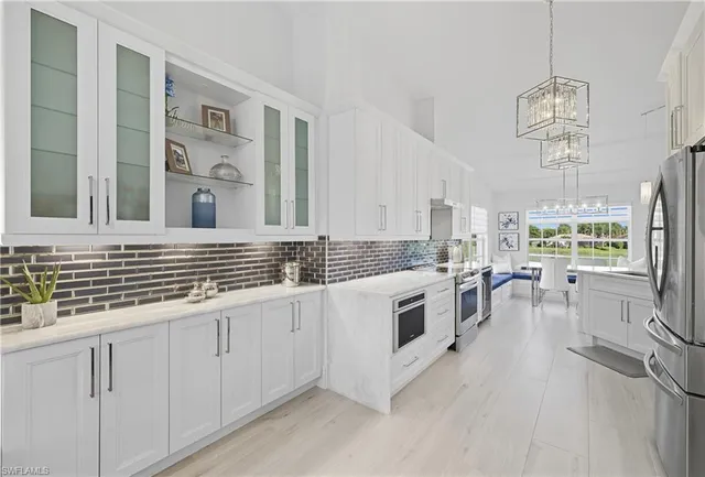 a kitchen with refrigerator cabinets and a sink
