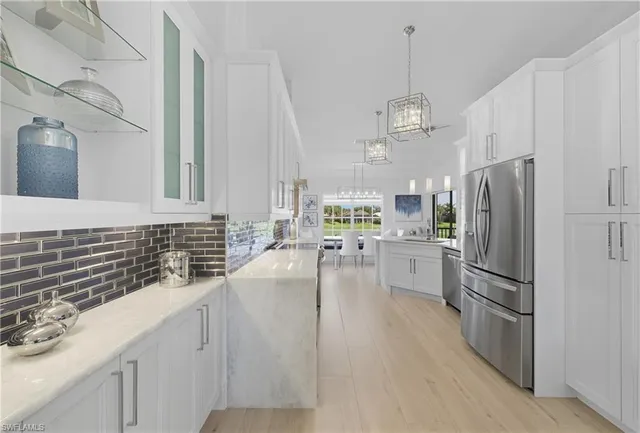 a kitchen with a stove sink and cabinets