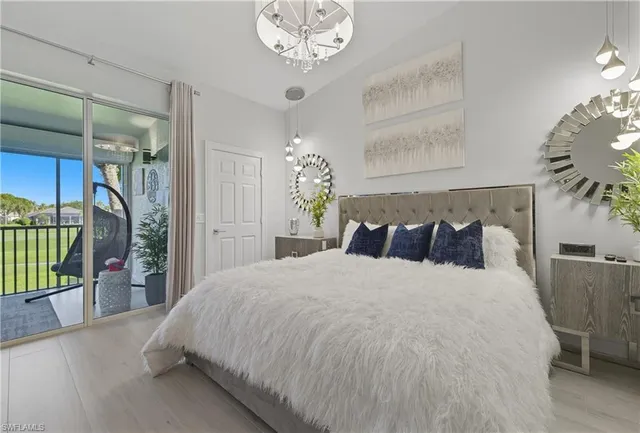 a bedroom with a bed mirror and a window