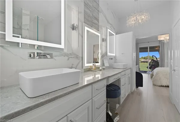 a large bed sitting in a bedroom next to a window