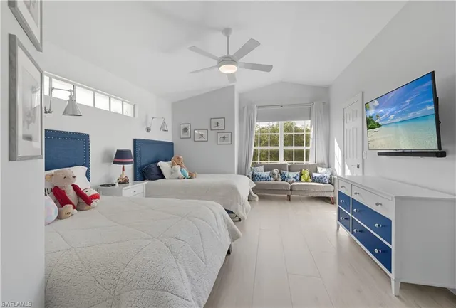 a bedroom with two beds and painting on the wall