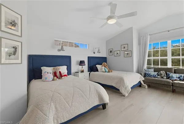 a bed room with two bed and a window