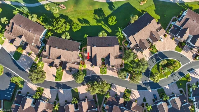 an aerial view of a residential houses with outdoor space