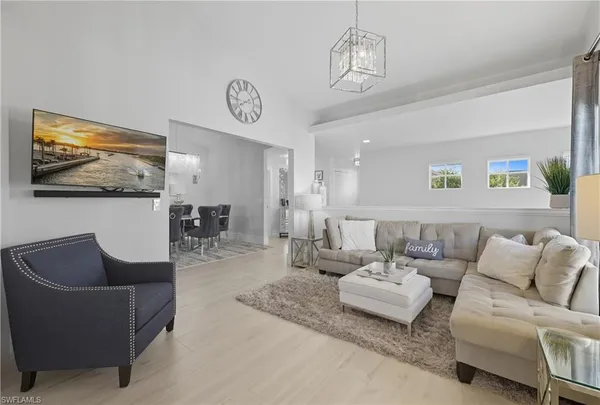 a view of a dining room kitchen and a chandelier