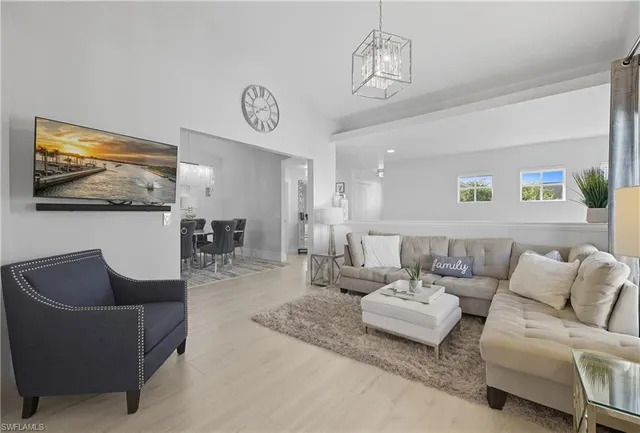 a view of a dining room kitchen and a chandelier