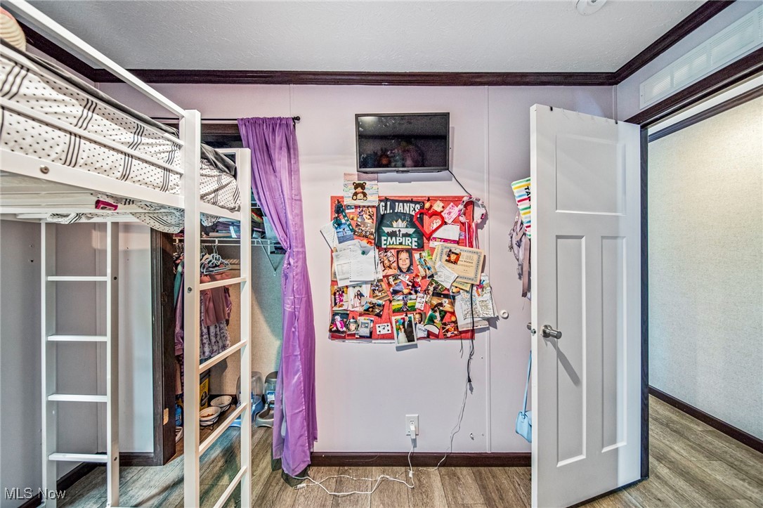 202 West Main Road, Unit LOT 13 Conneaut, OH 44030 - Photo 14 of 23 Bedroom with ornamental molding and wood finished floors