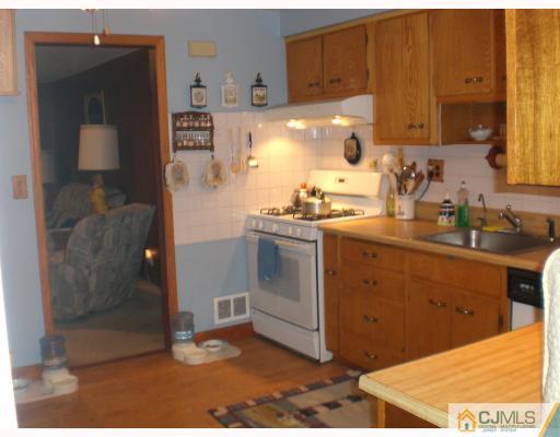 13 Magee Road Edison, NJ 08817 - Photo 4 of 7 a kitchen with a sink and cabinets