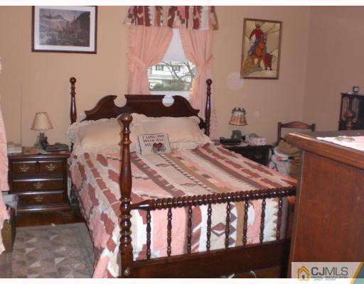 13 Magee Road Edison, NJ 08817 - Photo 6 of 7 a bedroom with a bed and a window