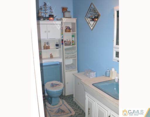 13 Magee Road Edison, NJ 08817 - Photo 7 of 7 a bathroom with a toilet a sink and shower