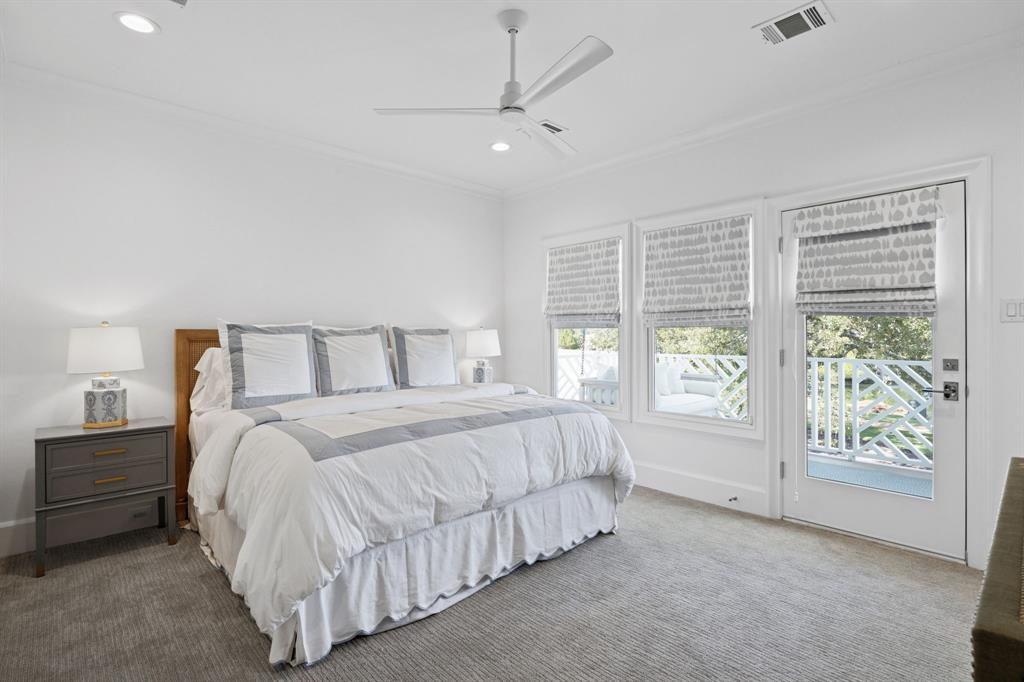 13450 Shumate Way Malakoff, TX 75148 - Photo 22 of 40 a bedroom with a large bed and a chandelier fan