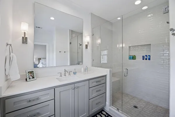 a bathroom with a shower sink double and mirror