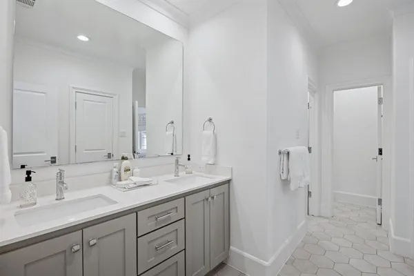 a spacious bathroom with double sink and a mirror