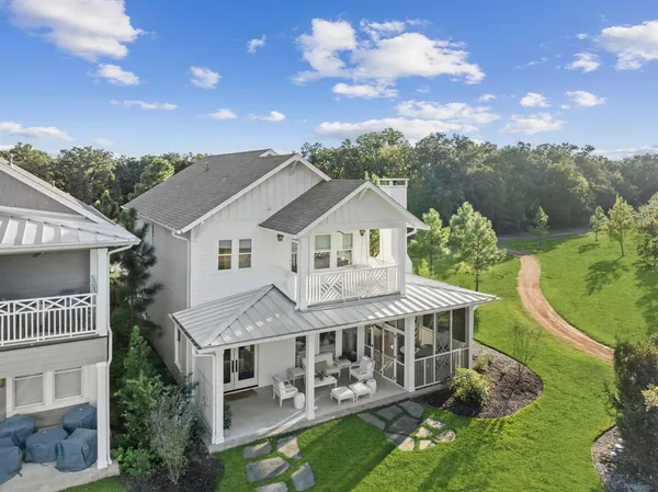 an aerial view of a house with a big yard