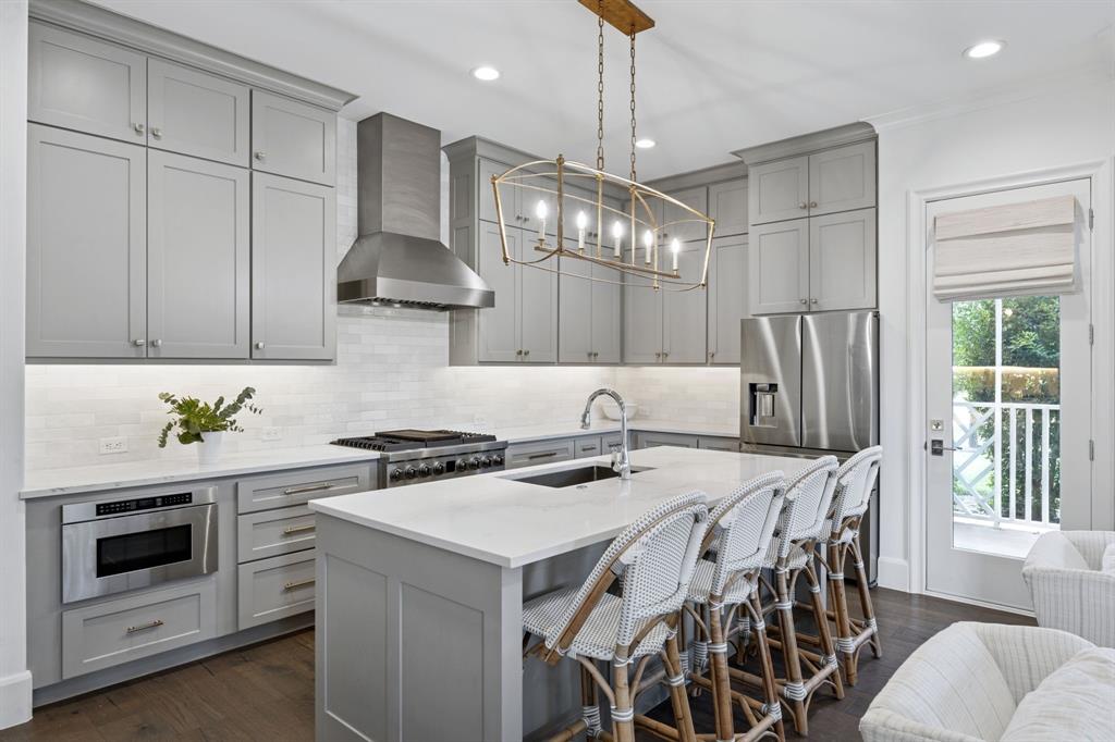 13450 Shumate Way Malakoff, TX 75148 - Photo 4 of 40 a kitchen with stainless steel appliances a stove a table and chairs