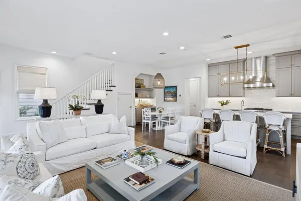 a living room with furniture kitchen view and a table