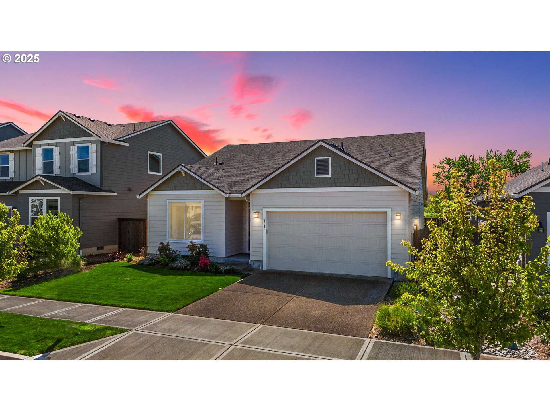 8707 North 1st Street Ridgefield, WA 98642 - Photo 1 of 40 a front view of a house with a yard and garage