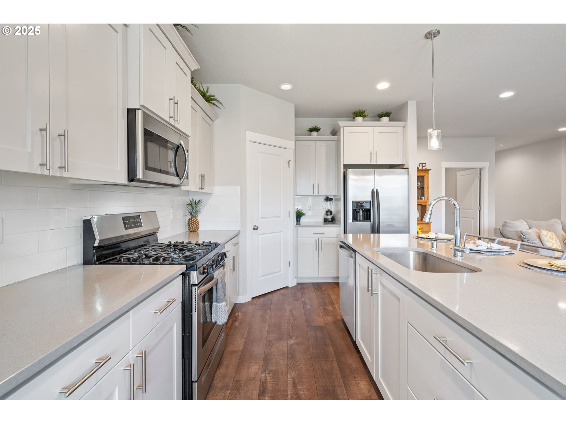8707 North 1st Street Ridgefield, WA 98642 - Photo 11 of 40 a kitchen with stainless steel appliances granite countertop a sink stove and refrigerator