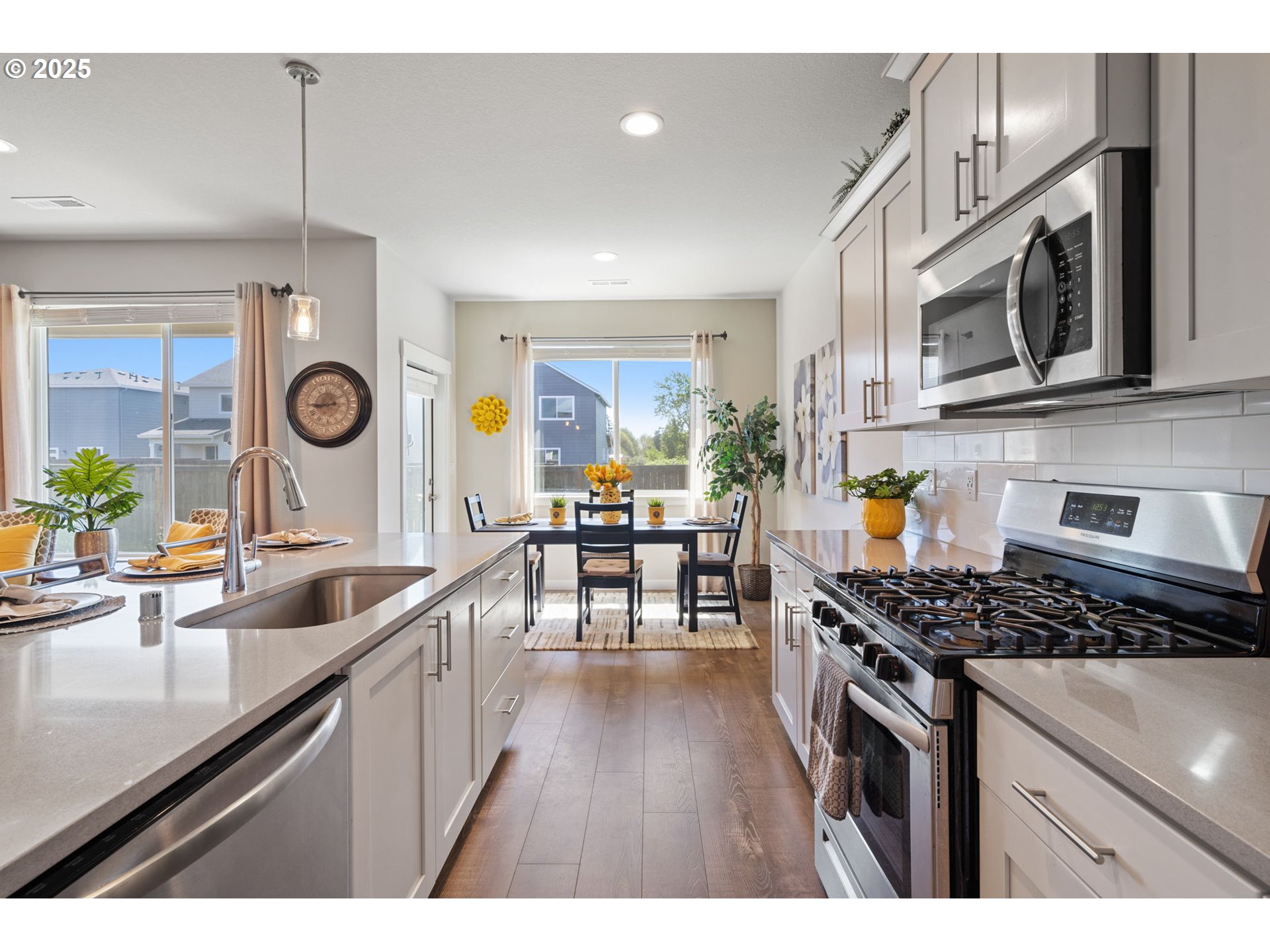 8707 North 1st Street Ridgefield, WA 98642 - Photo 12 of 40 a kitchen with stainless steel appliances granite countertop a sink a stove and a microwave