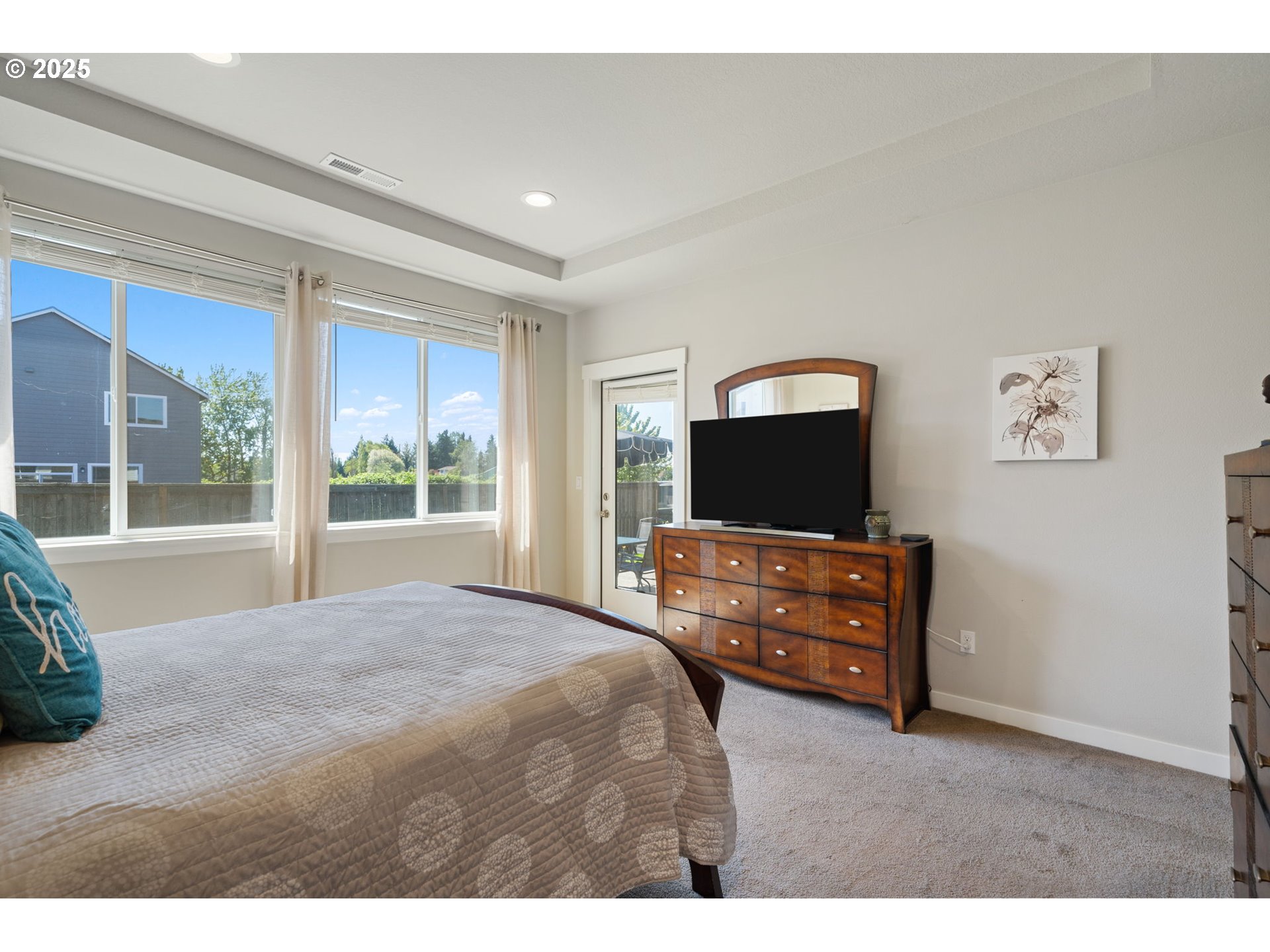 8707 North 1st Street Ridgefield, WA 98642 - Photo 21 of 40 a bedroom with a bed and a flat screen tv