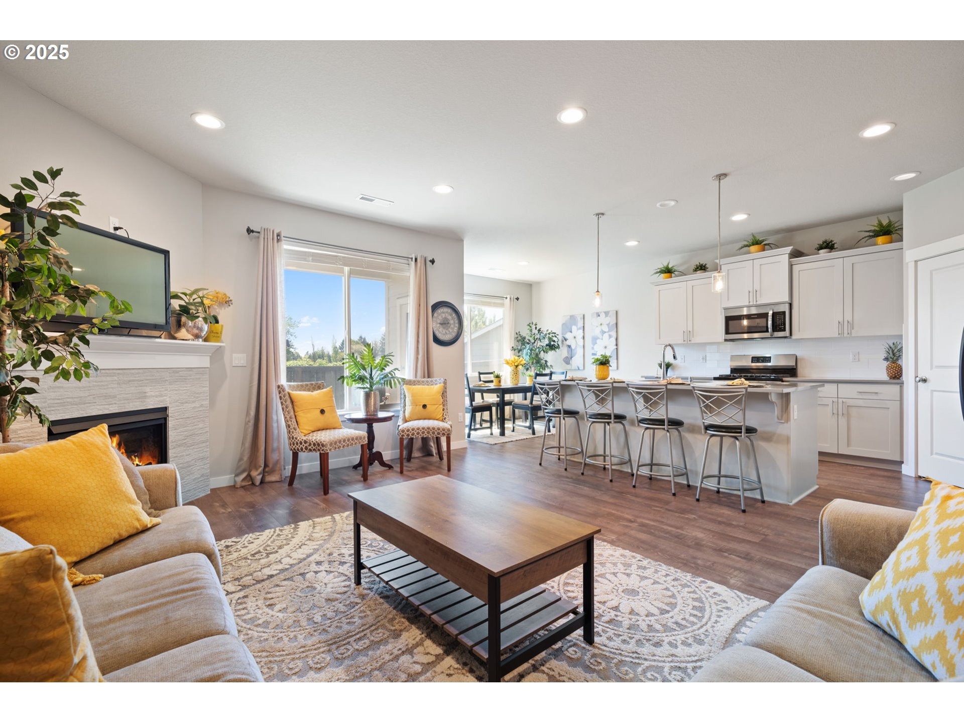 8707 North 1st Street Ridgefield, WA 98642 - Photo 5 of 40 a living room with fireplace furniture and a dining table
