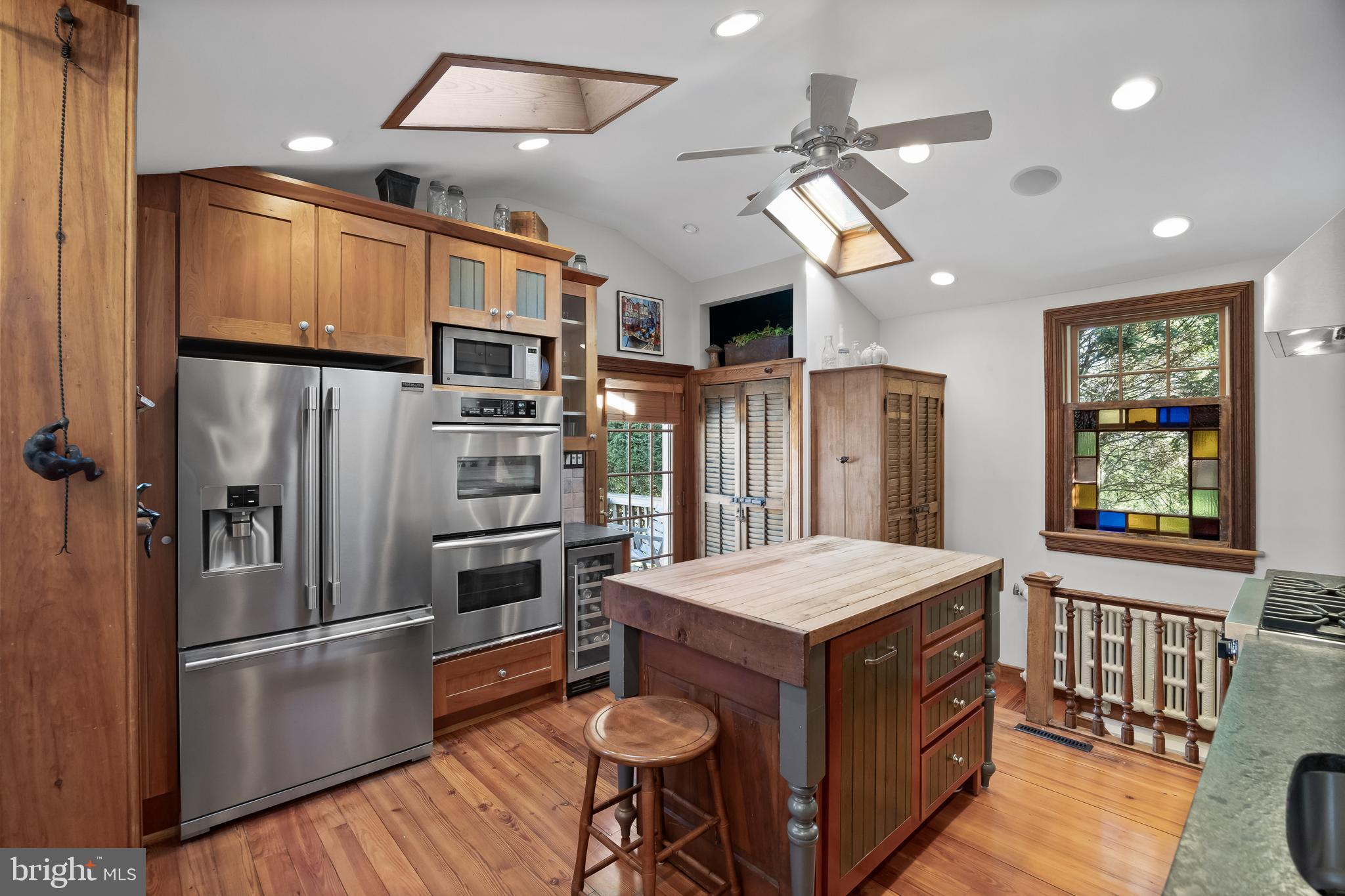 269 East 3rd Street Moorestown, NJ 08057 - Photo 15 of 52 a kitchen with stainless steel appliances kitchen island granite countertop a refrigerator a stove a sink dishwasher and a dining table with wooden floor