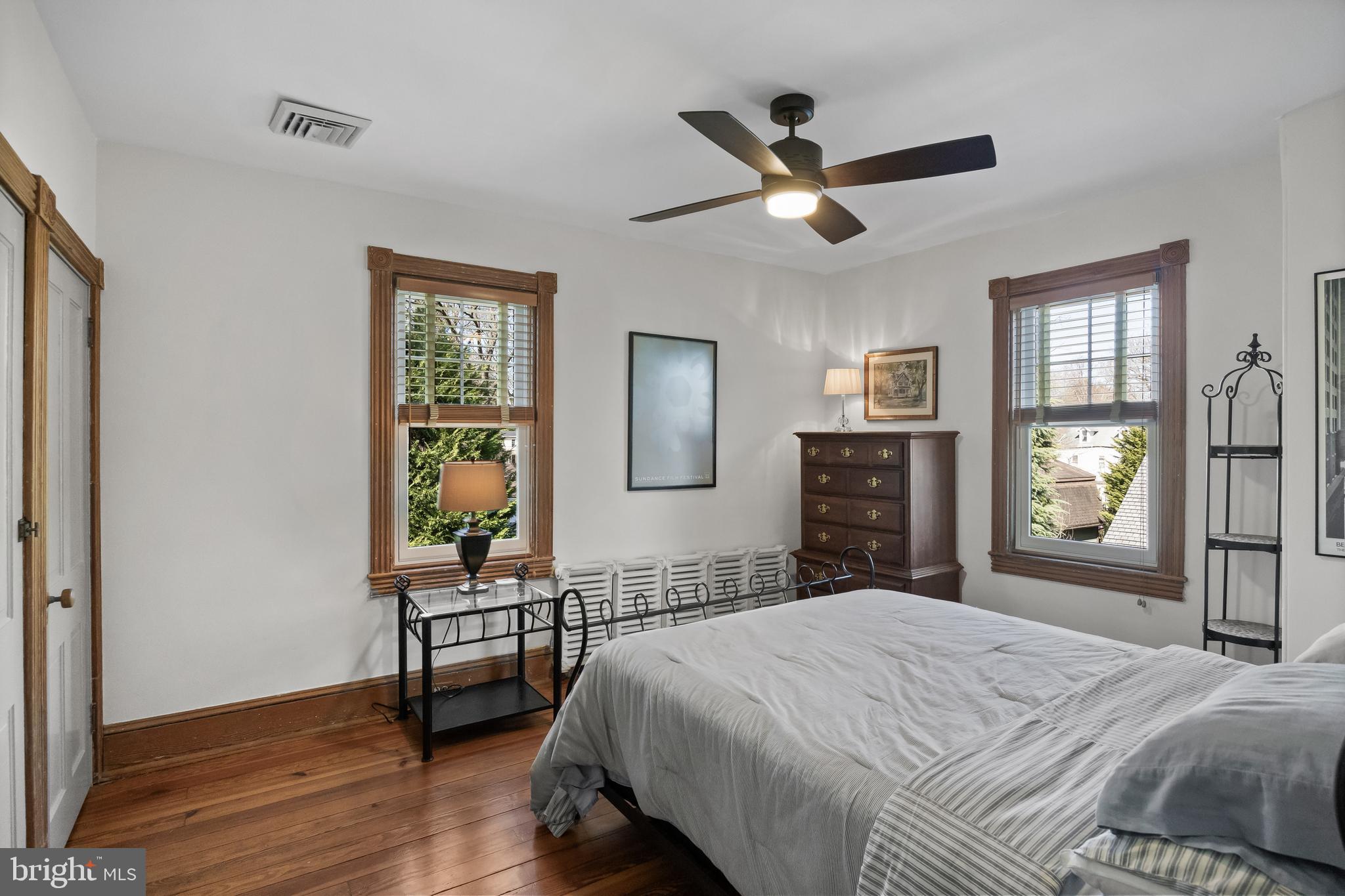 269 East 3rd Street Moorestown, NJ 08057 - Photo 26 of 52 a bedroom with a bed and a table in it with wooden floor