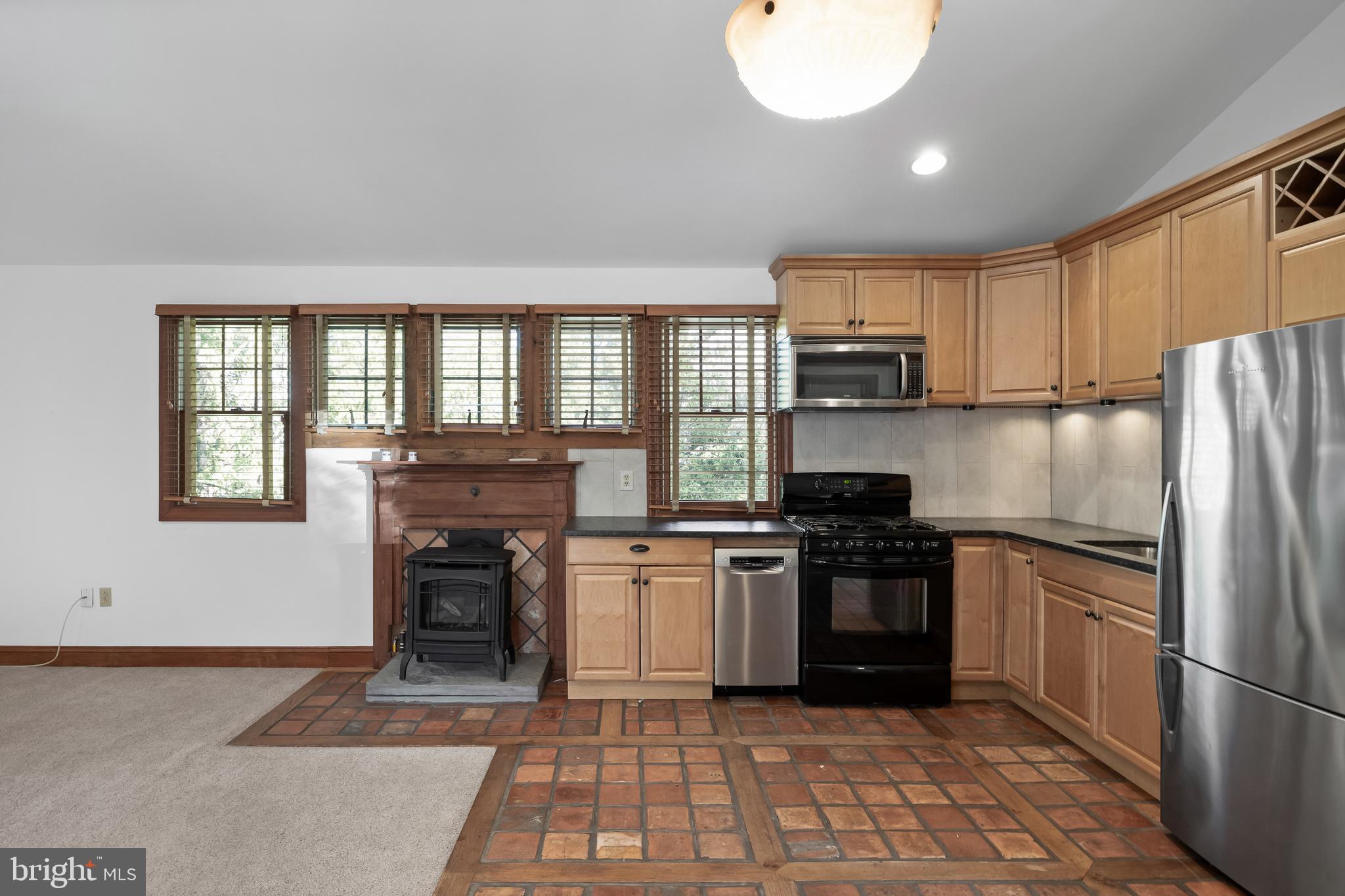 269 East 3rd Street Moorestown, NJ 08057 - Photo 38 of 52 a kitchen with kitchen island granite countertop a stove top oven a sink and a refrigerator