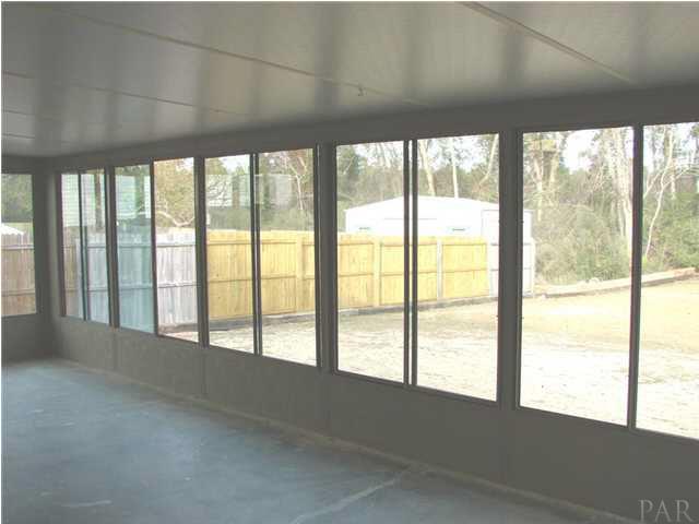 2740 River Run Road Navarre, FL 32566 - Photo 13 of 15 FLORIDA ROOM WITH SLIDING DOORS TO BACK YARD AND SIDE TO SIDE SLIDING WINDOWS!