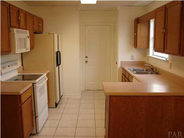 2740 River Run Road Navarre, FL 32566 - Photo 3 of 15 TILED KITCHEN ~ LOTS OF COUNTER SPACE, BUILT IN MICROWAVE ~ UPDATED STOVE AND DISHWASHER!