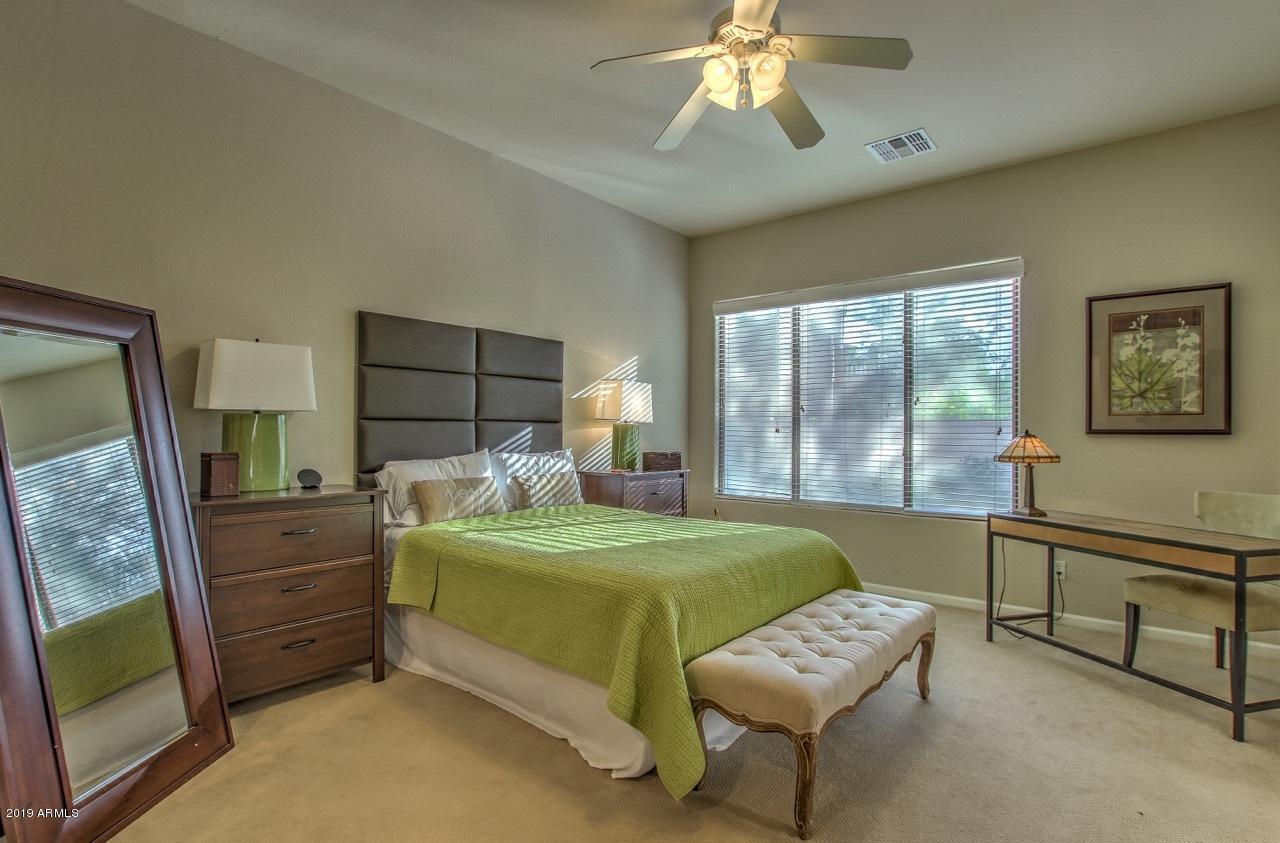 3977 East Hashknife Road Phoenix, AZ 85050 - Photo 16 of 28 a bedroom with a bed and a mirror on dresser