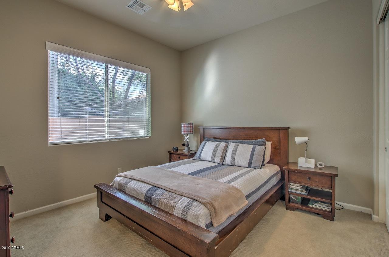 3977 East Hashknife Road Phoenix, AZ 85050 - Photo 21 of 28 a large bed sitting in a bedroom next to a window