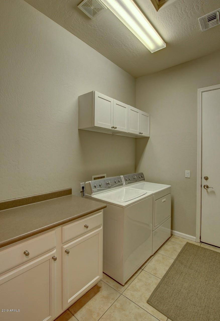 3977 East Hashknife Road Phoenix, AZ 85050 - Photo 24 of 28 a utility room with cabinets washer and dryer