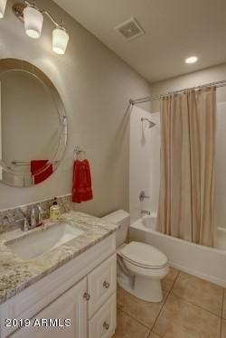3977 East Hashknife Road Phoenix, AZ 85050 - Photo 25 of 28 a bathroom with a granite countertop sink a toilet and shower