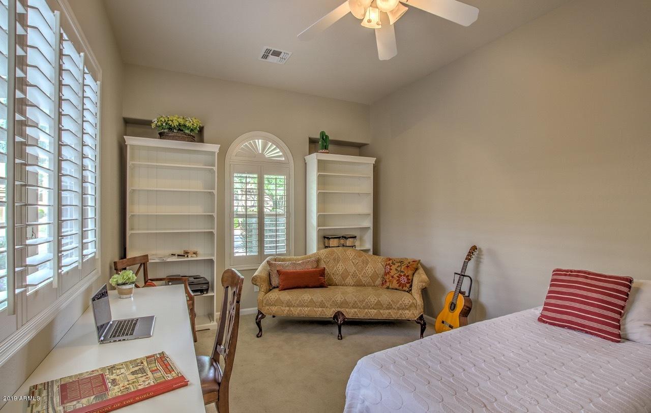3977 East Hashknife Road Phoenix, AZ 85050 - Photo 26 of 28 a bedroom with furniture and a large window