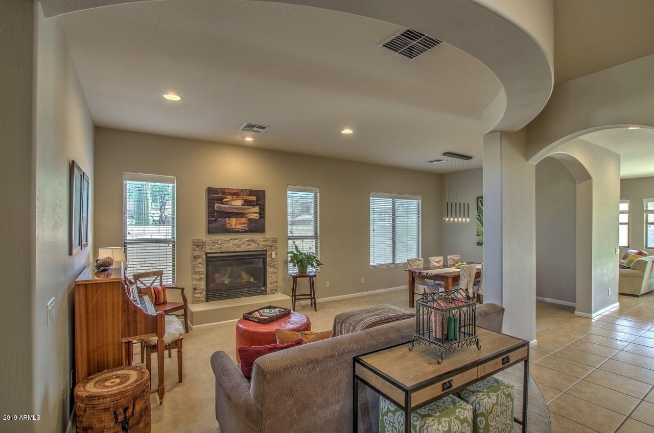 3977 East Hashknife Road Phoenix, AZ 85050 - Photo 4 of 28 a living room with furniture and a fireplace