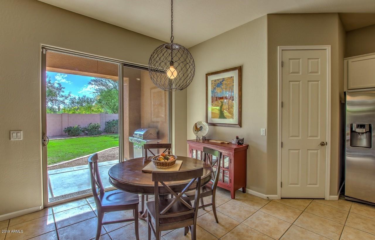 3977 East Hashknife Road Phoenix, AZ 85050 - Photo 9 of 28 a view of an outdoor dining space with a table and chairs