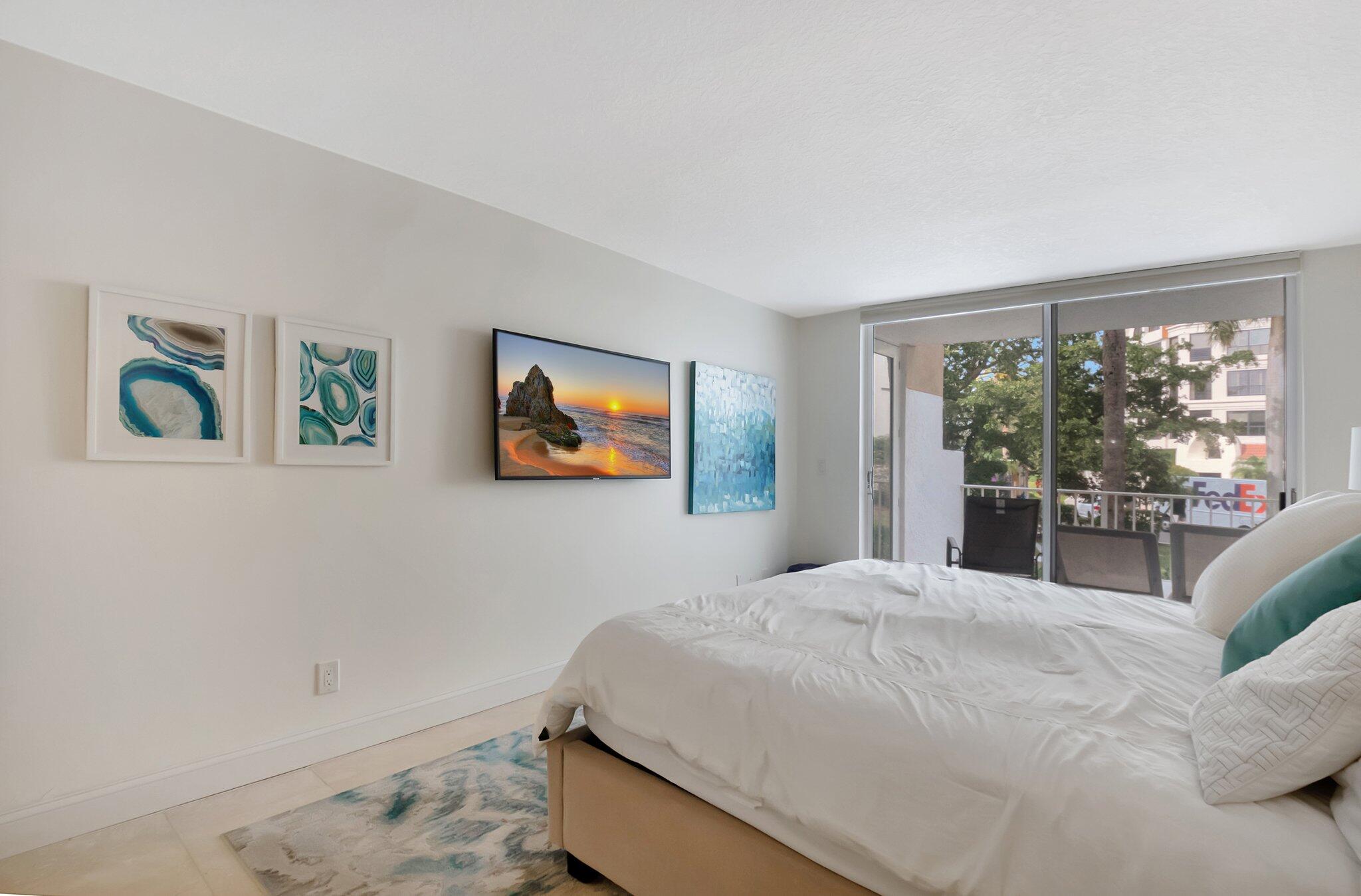 7370 Orangewood Lane, Unit 107 Boca Raton, FL 33433 - Photo 18 of 78 a bedroom with a large bed and a window