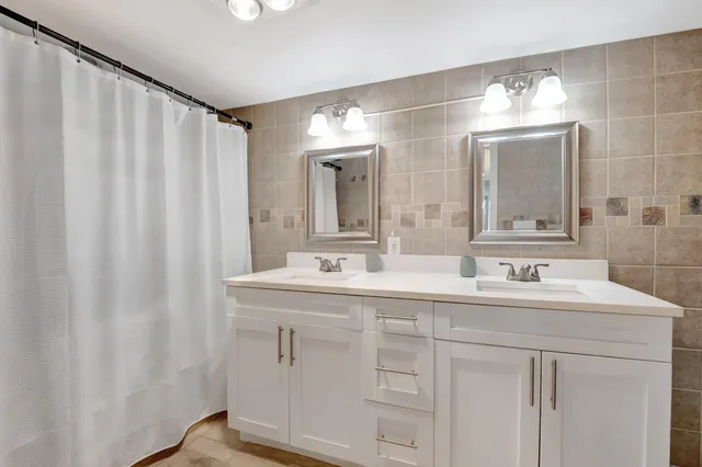 a bathroom with a sink toilet tub and shower