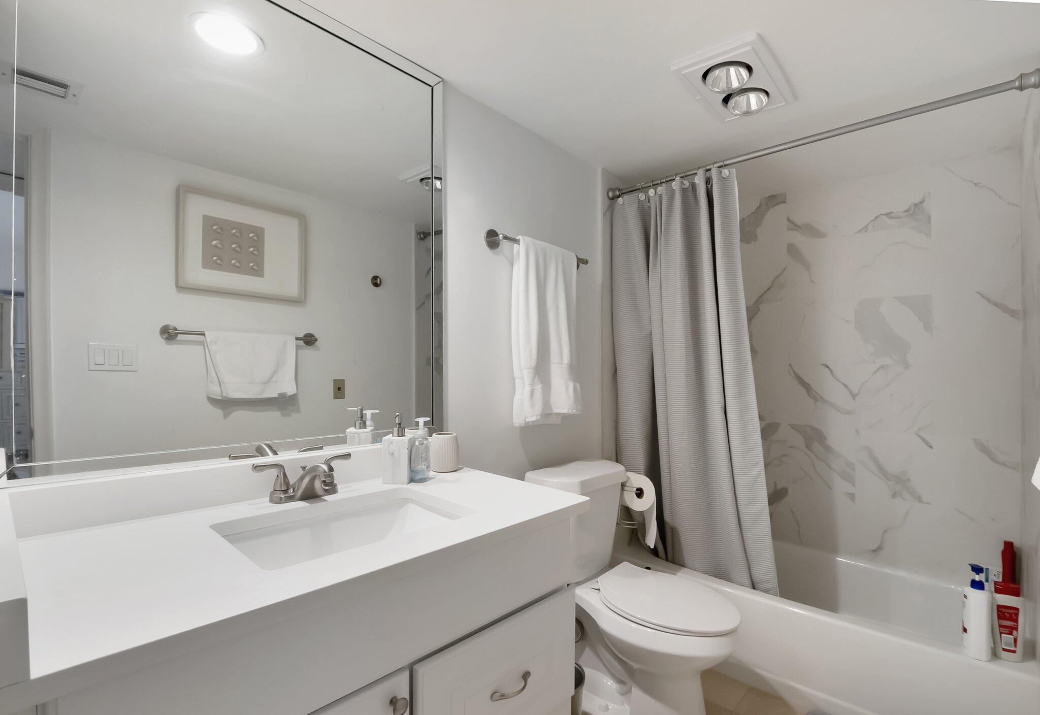 7370 Orangewood Lane, Unit 107 Boca Raton, FL 33433 - Photo 24 of 78 a bathroom with a sink toilet tub and shower