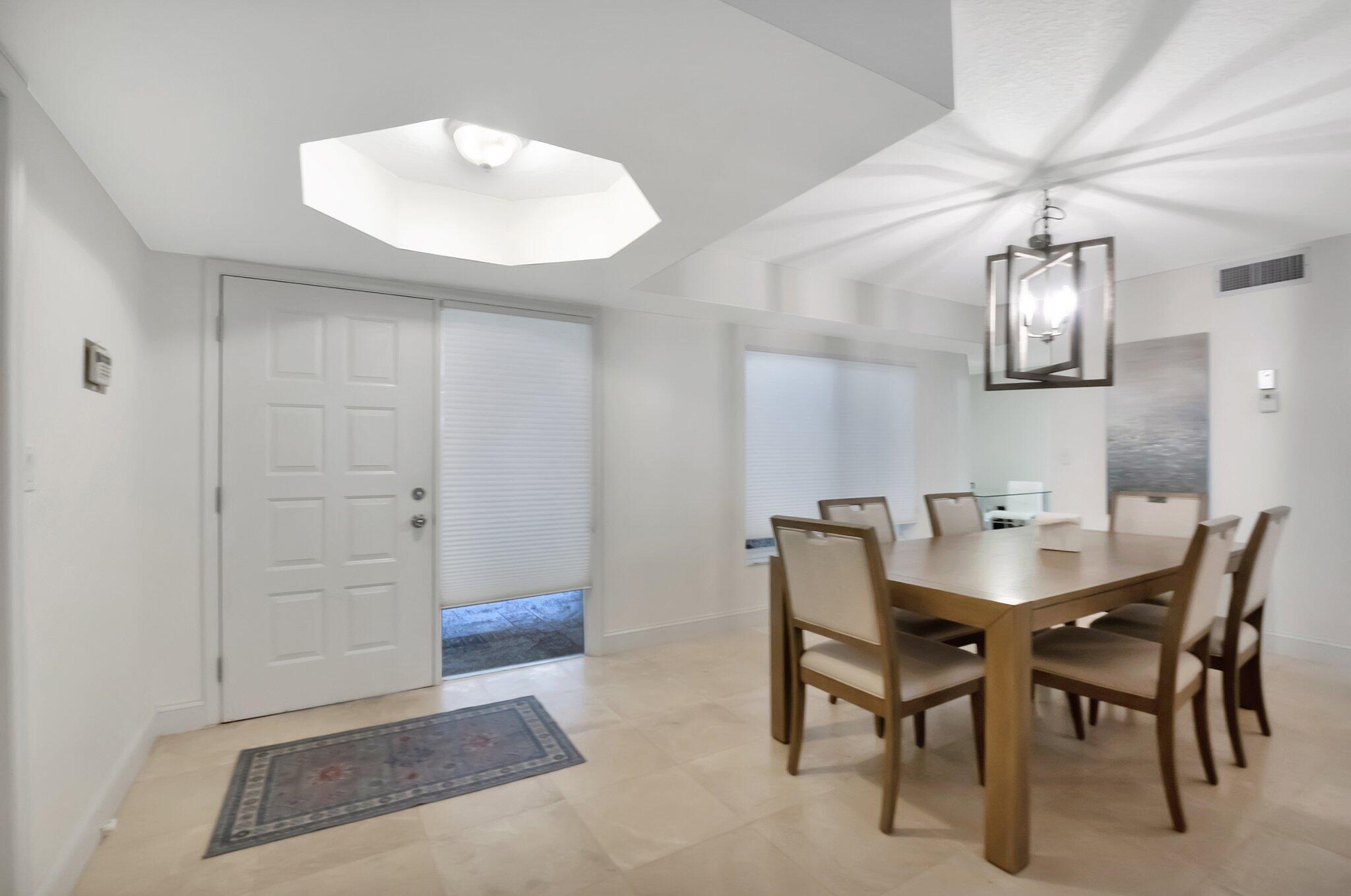 7370 Orangewood Lane, Unit 107 Boca Raton, FL 33433 - Photo 6 of 78 a view of a dining room with furniture and wooden floor