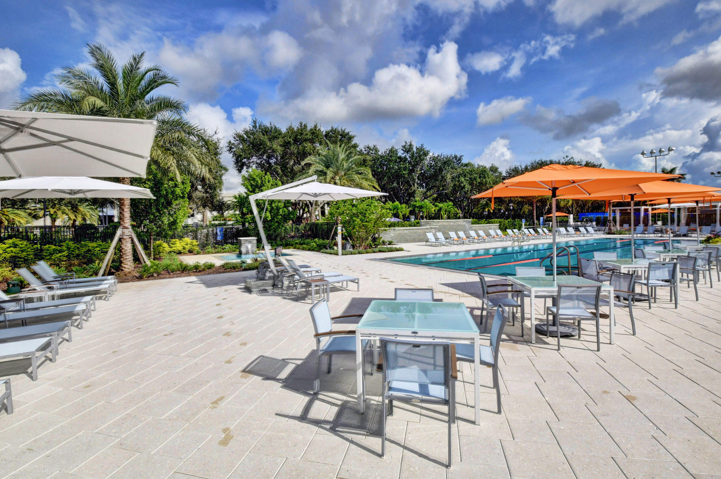 7370 Orangewood Lane, Unit 107 Boca Raton, FL 33433 - Photo 68 of 78 a view of patio with chairs and tables with a umbrella
