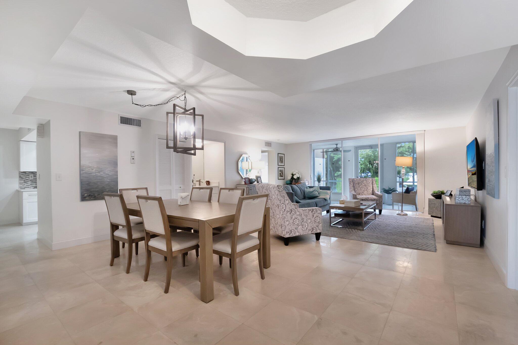 7370 Orangewood Lane, Unit 107 Boca Raton, FL 33433 - Photo 7 of 78 a view of a livingroom with furniture and a chandelier